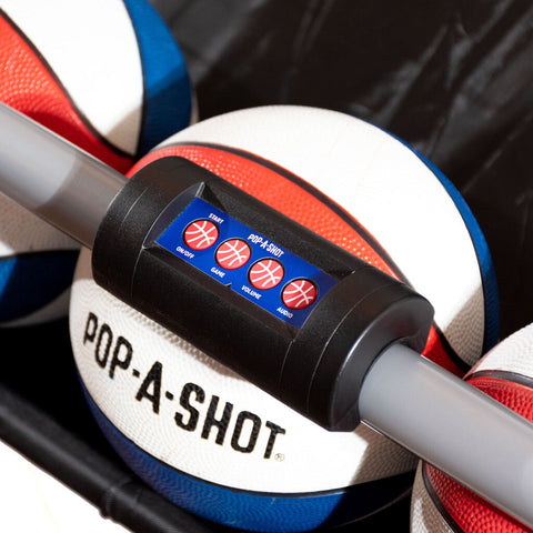 close up of a pop-a-shot game controller in front of a red white and blue mini pop-a-shot basketball