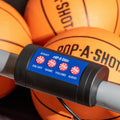 close up of pop-a-shot game controller with pop-a-shot mini basketballs in background